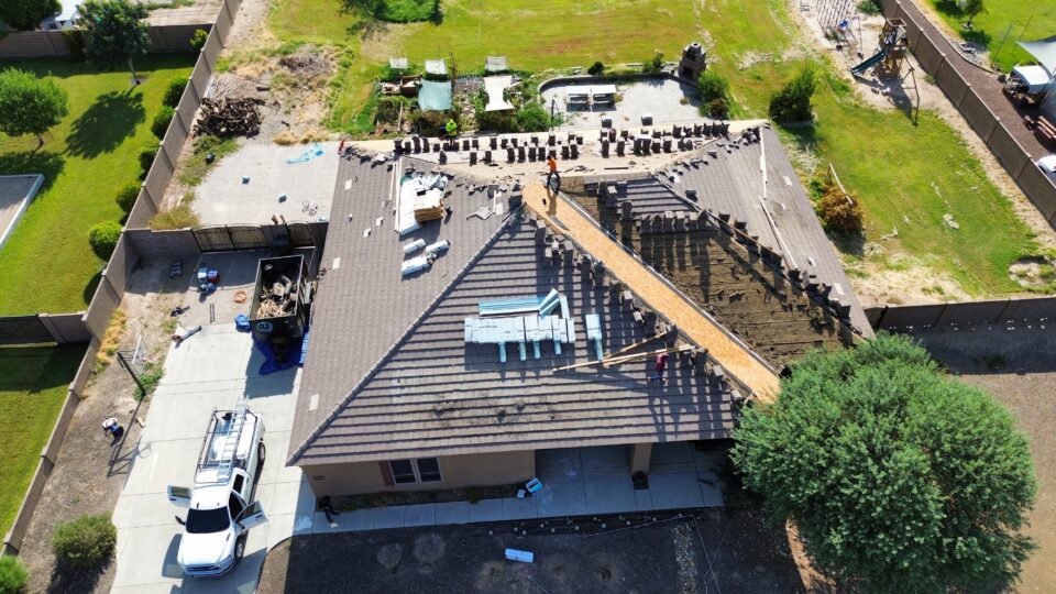 Tier One Roofing team replacng a roof